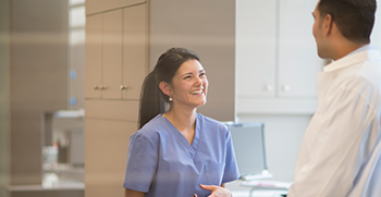 A doctor having a pleasant encounter with a nurse