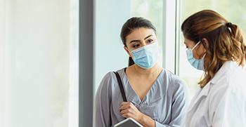 A doctor speaking with her patient during a visit