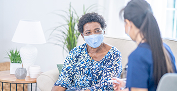 A woman speaking with her doctor during a primary care visit